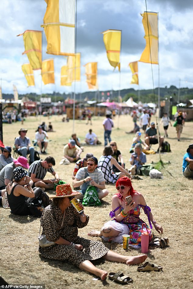 Festivalgoers relax in the morning sunshine ahead of more acts on today