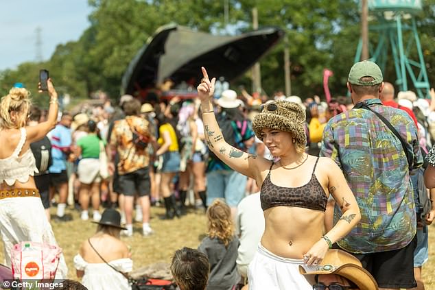 A woman enjoys the music as Glastonbury gets into the swing at Worthy Farm