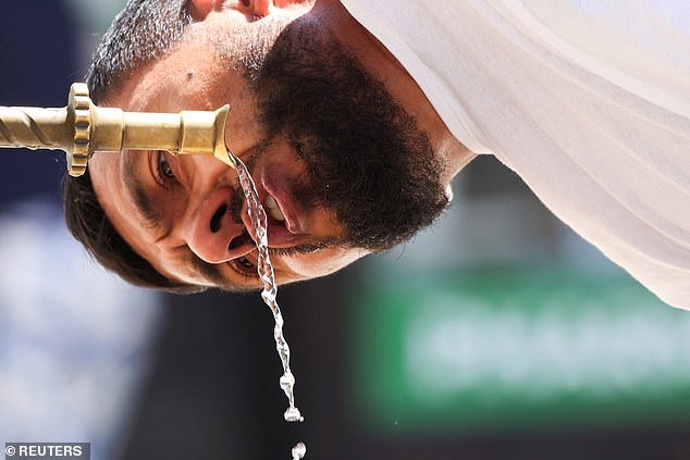BOSNIA AND HERZEGOVINA: A tourist drinks water at a fountain during a heatwave in Sarajevo, June 25