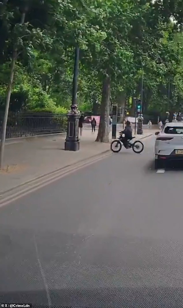 The man, wearing running clothes, was on his phone as the thief brazenly mounted onto the pavement and quickly snatched it from him