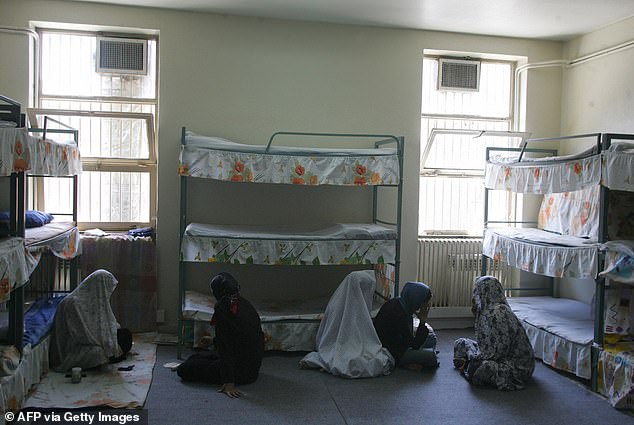 Iranian women inmates sit at their cell in the infamous Evin jail, north of Tehran