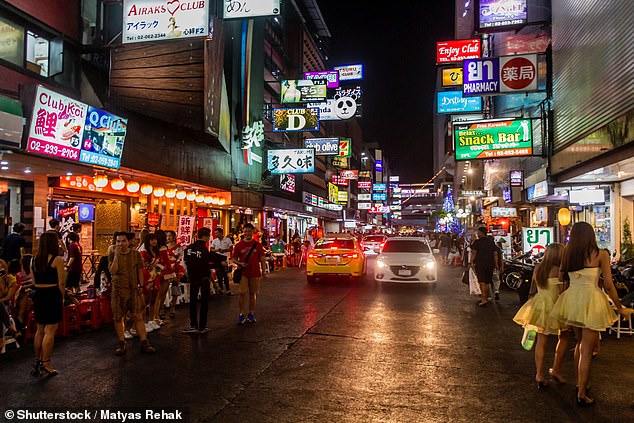 A woman's husband thinks his Thai massage with a 'happy ending' doesn't count as cheating (stock image of the Patpong red-light district in Bangkok, Thailand)