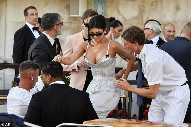 She was seen being helped into the boat to travel to the wedding by an entourage of help