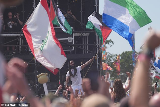One of the Bob Vylans waves a Palestine flag during their Glastonbury set