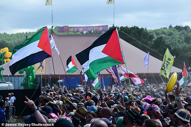 Many people in the crowd gathered for Bob Vylan's performance waved Palestinian flags in a show of support with people in Gaza