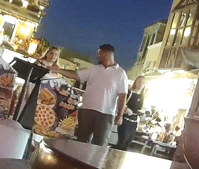 Another worker at Eat Lovers Taverna standing out front of the restaurant trying to get tourists to come in. The woman shakes her head and continues to walk off