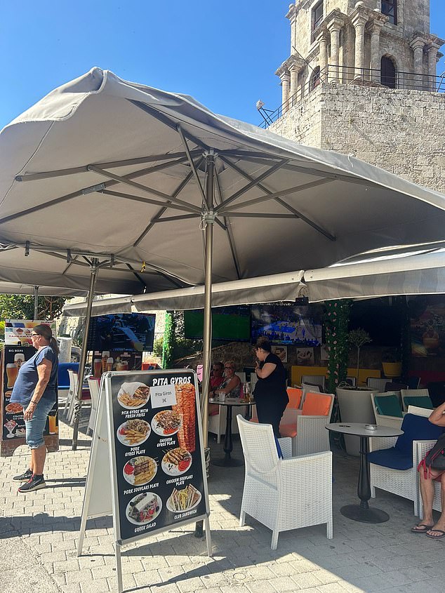 From the outside during the day, there is no indication of the name of the restaurant. The very small sign is covered completely by large parasols