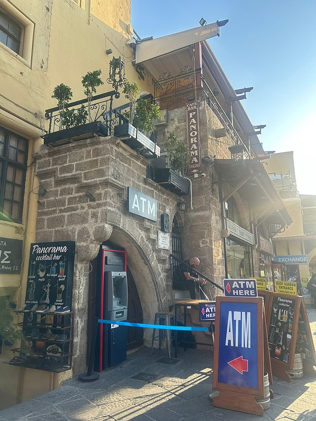 An ATM outside another bar, Panorama, which has 1.7 star reviews on TripAdvisor