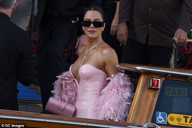 She toted her essentials in a matching handbag and shielded her eyes with dark shades