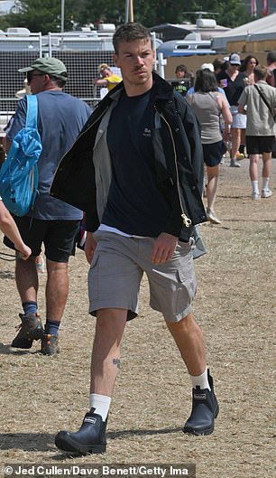 He cut a casual figure in a black T-shirt and grey shorts