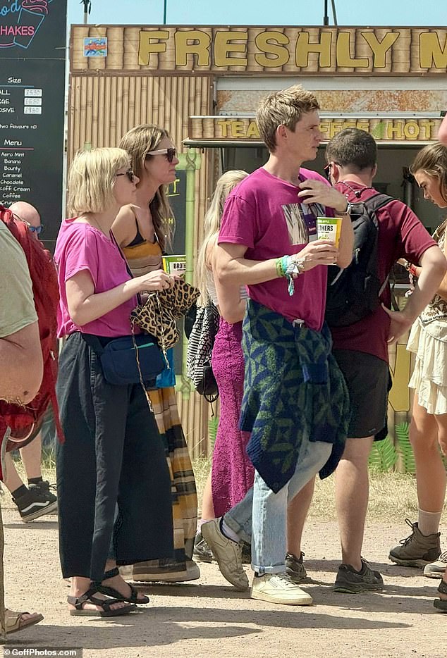 Eddie Redmayne was spotted with his wife Hannah as he both put on an vibrant display in a pink top