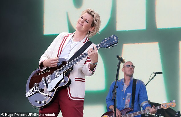 She cut a smart figure in red trousers and a white jacket as she belted out her songs and played guitar