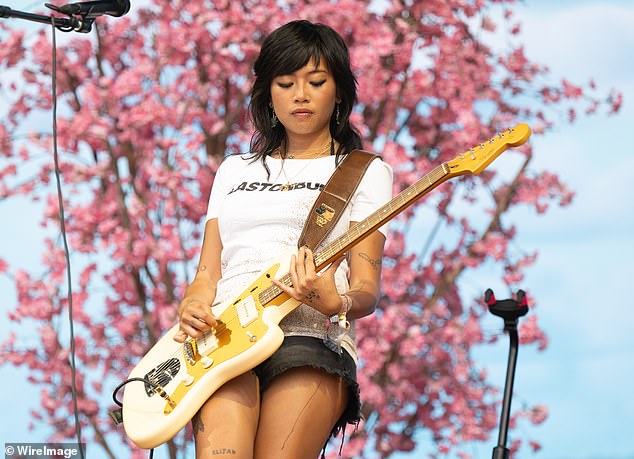 The indie singer sported a white T-shirt with 'Glastonbury' printed across it, which she styled with distressed denim shorts