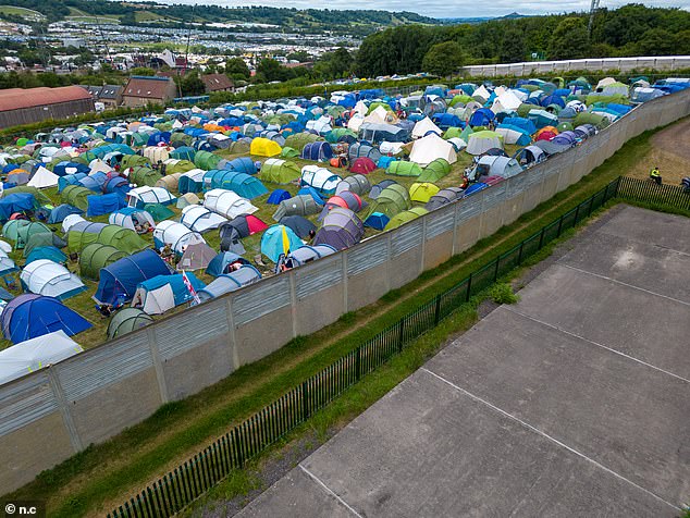 The enormous fences tower above the campsite at a height of 4 metres tall