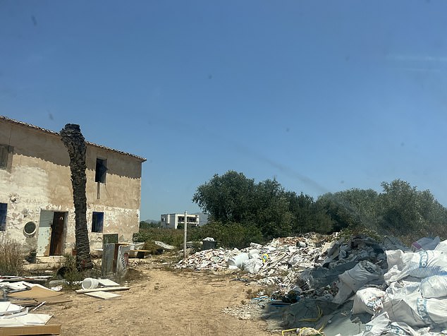 On the encampment there is one makeshift road that snakes uphill and passes several abandoned properties
