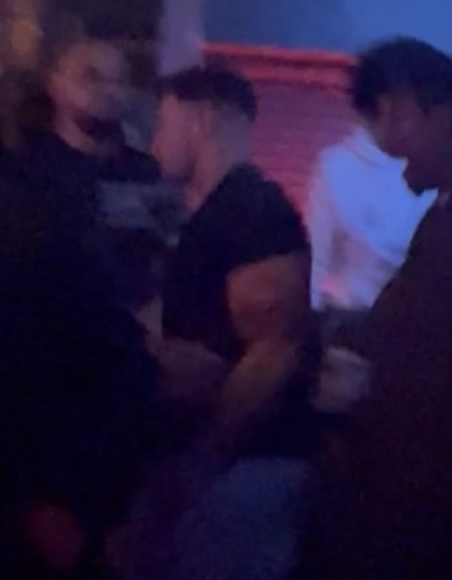 He chatted intently his brother's partner before she wrapped her arms around his neck for a friendly embrace