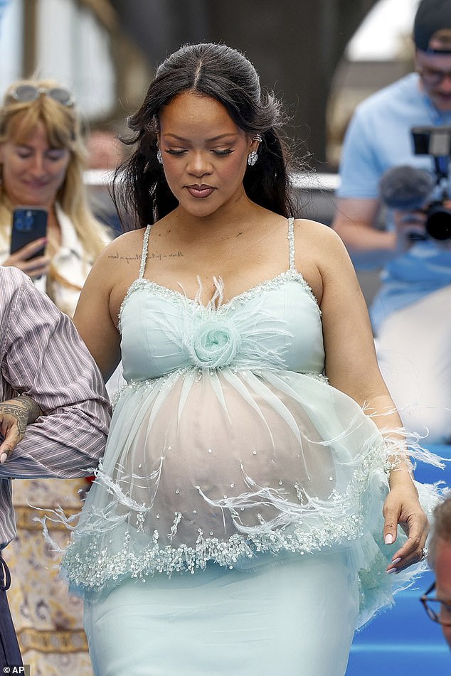Taking to the red carpet, the mum-of-two - who is expecting her third child - looked chic in a light turquoise mesh gown which swept across the floor