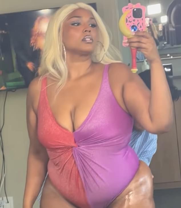 Her new album also featured a video that showed her posing in the swimsuit while a gentleman sprayed her with what appeared to be sunscreen