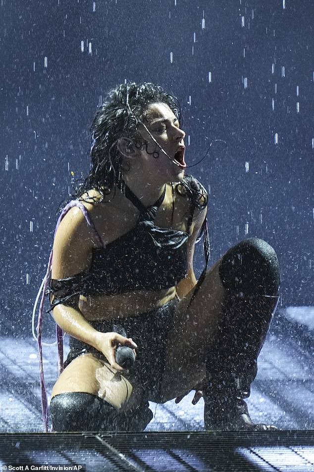 The singer, 32, showed off her toned figure in tiny black leather hot pants and a mesh skull crop top