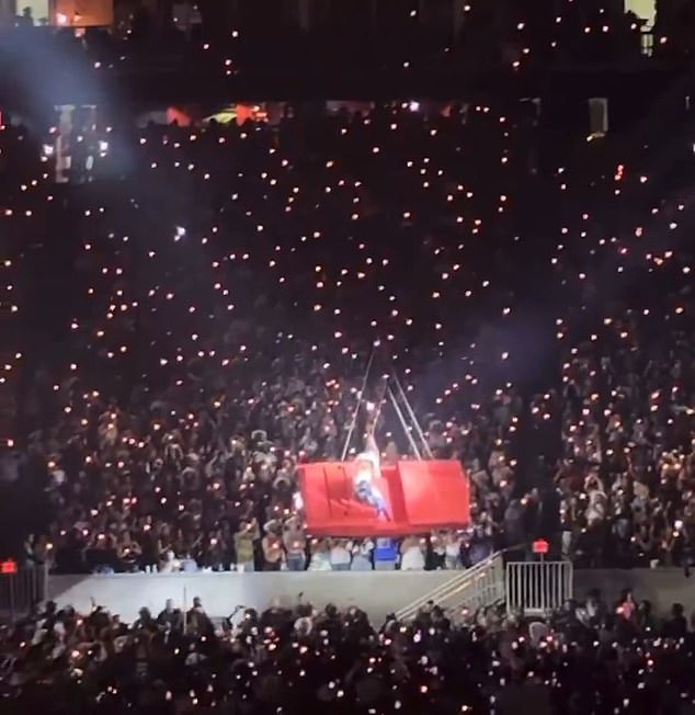 The car, hanging from a harness, was slowly and safely brought back down to the stage
