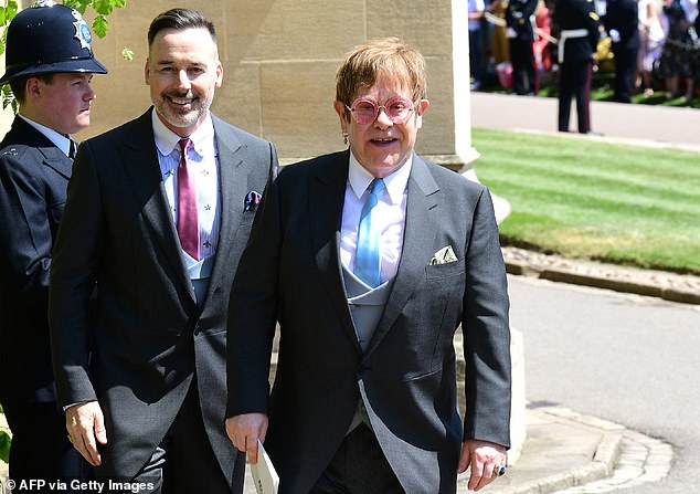 Elton John and husband David Furnish leave after attending the wedding ceremony of Harry and Meghan