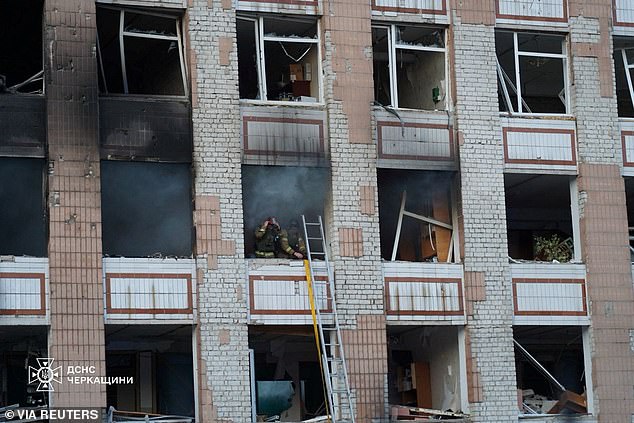 Firefighters work at the site of an apartment building damaged during Russian drone and missile strikes