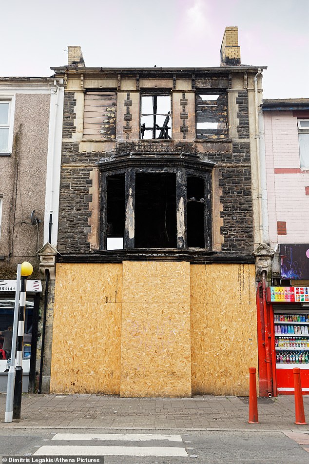 Many shops and buildings in the town are now derelict (Pictured: a burnt out former business)