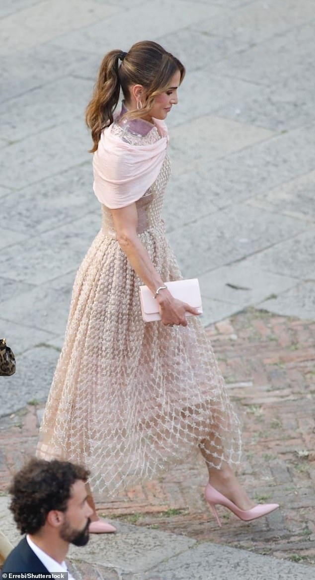 In a bid not to draw attention away from the extraordinary Fendi gown, she paired it with a plain ream clutch bag and accessorised with a simple silver jewellery bangle and hoops