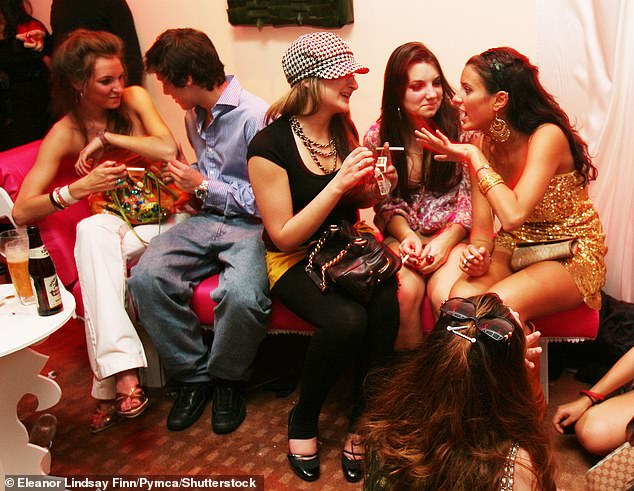 A group of women smoke as they chat at the Nobu Metropolitan Hotel in London in 2006