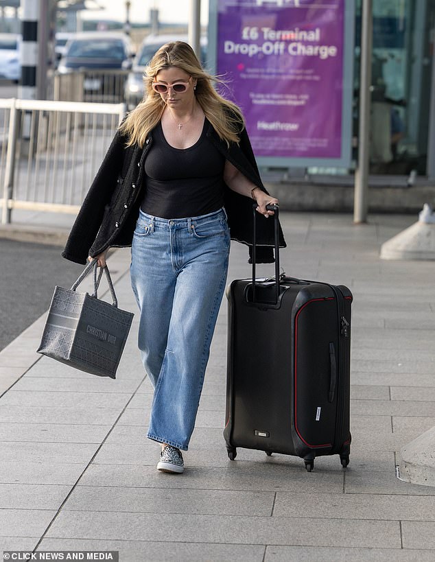 The former Neighbours star, 42, touched down at Heathrow's Terminal 5 on Saturday