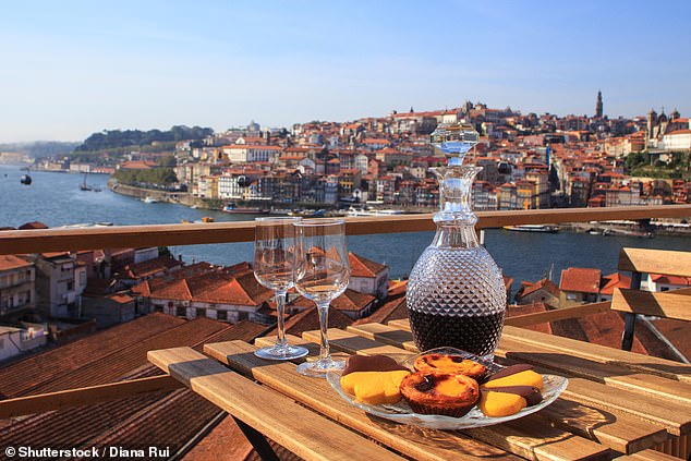 The Algarve has progressive tax rates, but it helps that the cost of living is 37.5 per cent lower than in the UK. Pictured, wine and sweet treats with a view of Porto
