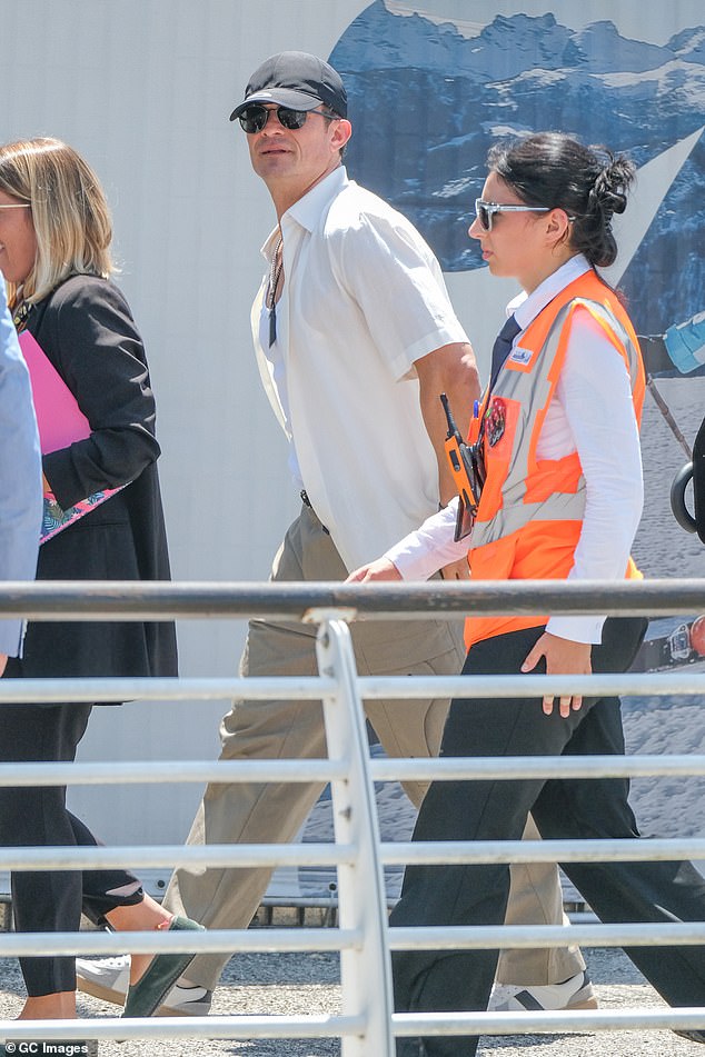 Orlando Bloom, 48, looked cool but casual in his departure ensemble - optioning for beige cargo pants, white vest and short-sleeved over shirt. The actor wore a baseball cap and sunglasses to shield himself from the sun