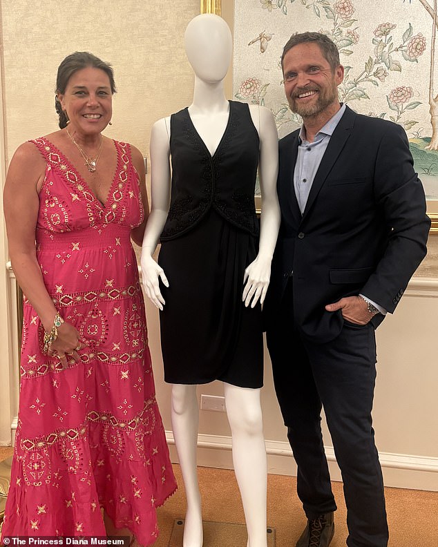 Renae Plant and Livinio Stuyck Sanchez pose with Princess Diana's 1995 Catherine Walker Black Cocktail Dress which sold for $260,000