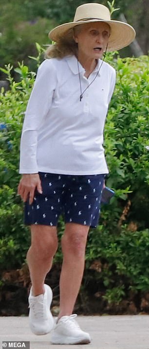 Her snappy outfit included a nautical chic set of navy and white shorts, teamed with a long-sleeved polo shirt and an elegant wide-brimmed straw hat