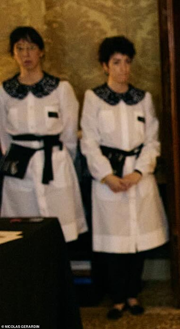 In the background of one of the snaps were two female staffers wearing somewhat outdated maid outfits - consisting of white pinafores with black detailing to the collars and belt tie