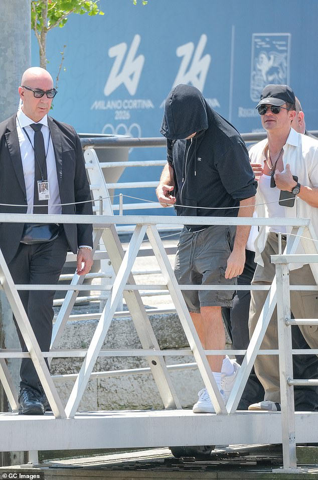 DiCaprio, 50, tried to keep a very low profile, covering up in a lightweight black hoodie over a pair of gray shorts and  white sneakers