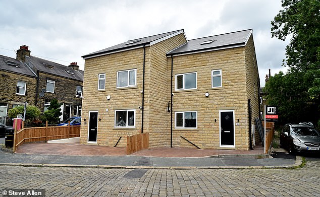 The controversial semi-detached homes sprung up on the site of a former pub car park in Bradford, West Yorks