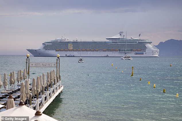 A huge cruise ship pictured anchoring in Cannes bay in front of the beach