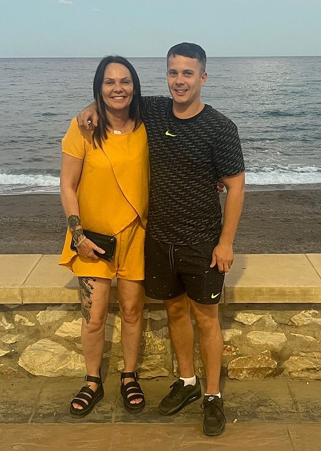 Brett stands by the seafront with his arm around his mum Sandra