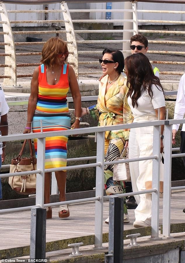 While Oprah looked chic in all-white, as she wrapped an arm around Kris' shoulders and listened intently to her pal