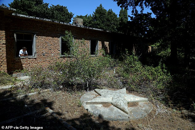 Pictured: A school once there for the children of Albanian soldiers living on Sazan. The Soviet Star is prominently feature