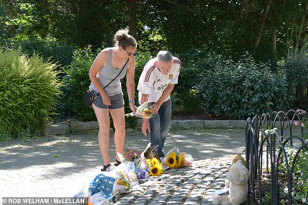 But local man Adam Ramet, 54, was quick to emphasise to MailOnline the supports have been there for a long time. Pictured: People lay flowers in the park today