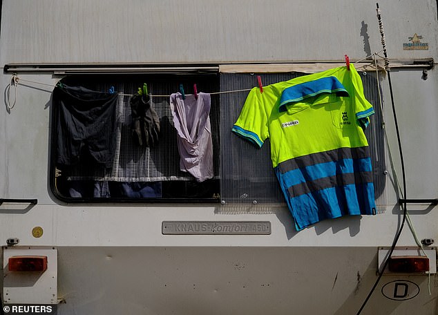 There simply is not enough housing to accommodate the millions of tourists who visit each year, leading to a surge in illegal holiday rentals. Pictured: A worker's clothes hang out to dry behind of their motorhome
