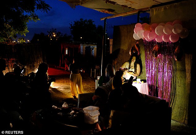 Pictured: Can Rova 2 resident, Rosario, 28, celebrates her birthday inside the makeshift settlement