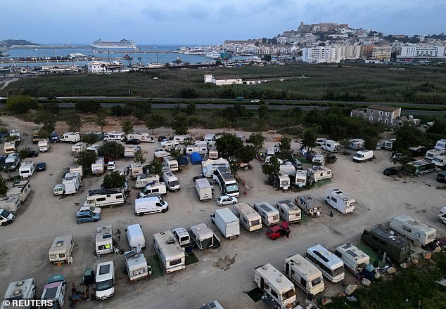 A general drone view shows motorhomes where workers with their families live