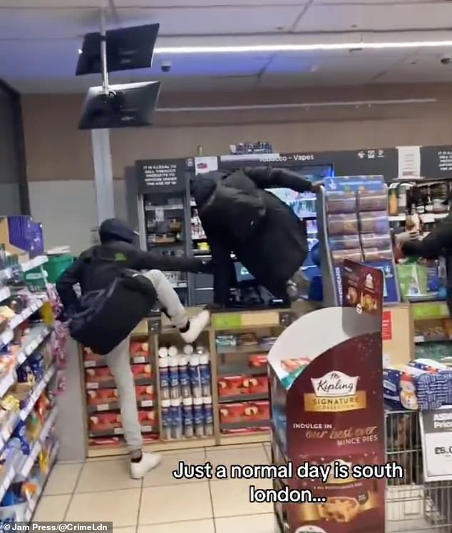 Thieves jump over the store counter at an Asda petrol station in Battersea in December 2024