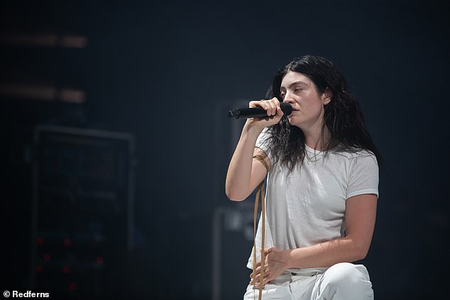 According to The Sun, the Teams hitmaker was spotted 'getting close with the musician on stage' after playing a surprise set at the Woodsies stage on Friday (pictured)