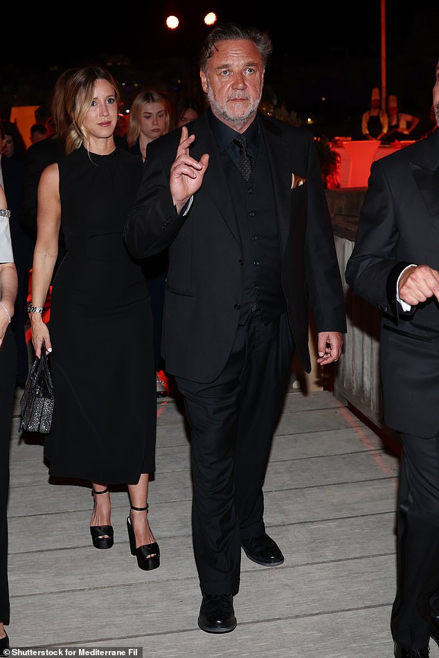 Russell's fiancée Britney Theriot also attended the event, and looked equally stylish in a longline shift dress
