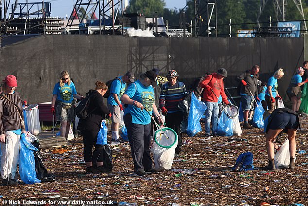 The clean-up team began picking up thousands of discarded items including paper cups and food containers as festival-goers began leaving the site.