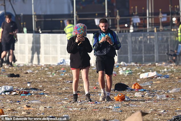 A pair of Glastonbury attendees pictured this morning making their way out of Worthy Farm